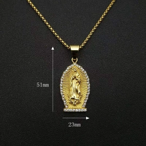 Detailed view of gold Virgin Mary pendant with rhinestones measuring 51mm by 23mm
