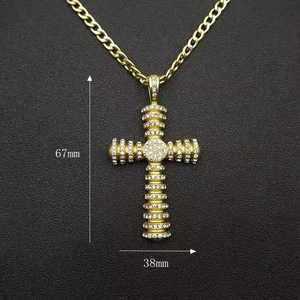 Detailed close-up of a gold hip-hop cross pendant with micro-inlaid rhinestones