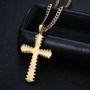 Gold hip hop cross pendant necklace with cuban chain on black jewelry box background