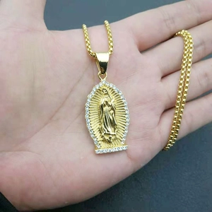Close-up of gold plated Virgin Mary pendant with sparkling rhinestones on box chain