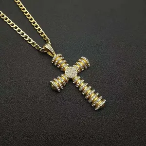 Detail of hip-hop cross pendant with micro-pave crystals on gold plated chain link