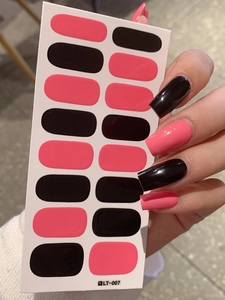 Detail of pink and black color-block nail stickers with glossy finish on fingers
