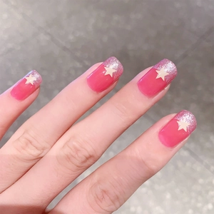 Pink jelly press-on nails with silver glitter gradient and white star decorations
