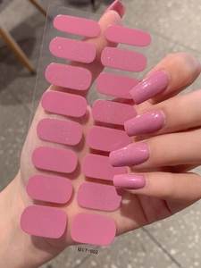 Detailed view of pink glitter nail stickers with silver shimmer in long rectangular shape