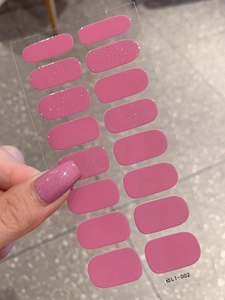 Detail of dusty rose nail polish stickers with glitter finish on transparent backing