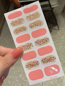 Macro detail of LT-015 pink gradient nail stickers with gold foil and glitter flakes