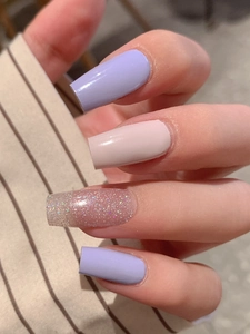 Detail of lavender purple and pink long square nails with holographic silver glitter