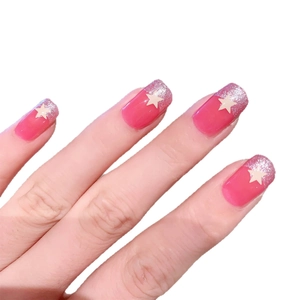 Pink press-on nails with silver glitter gradient tips and white star patterns