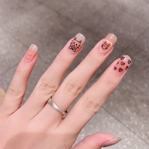 Close-up of pink jelly nail stickers with cat and rabbit patterns and silver rings