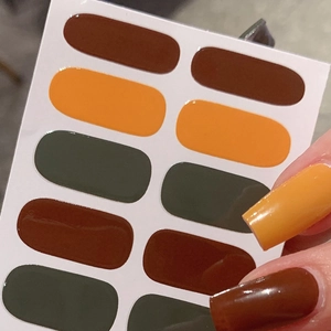 Glossy self-adhesive nail stickers in dark autumn tones like brown, yellow and green