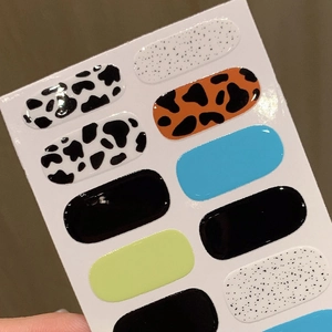Colorful leopard and cow print self-adhesive nail stickers with glossy gel finish texture