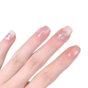 French tip nail wraps in pale pink and beige with silver glitter and star accents