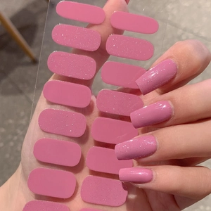 Pink glitter nail stickers with adhesive backing showing various sizes and application