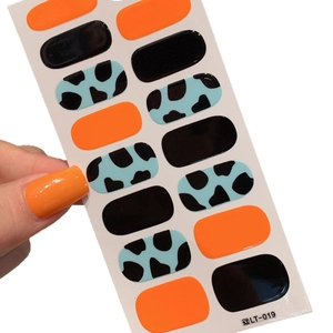 Bright orange and black glossy nail art stickers with cow print patterns 14 pieces set