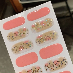 Pink gradient nail stickers with glitter and gold foil flakes on white backing