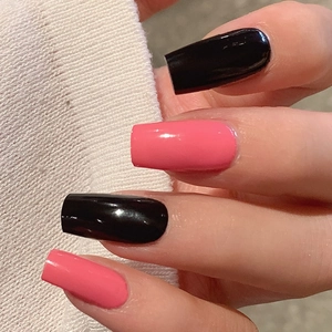 Glossy pink and black long square press-on nails shown against a white knit sleeve