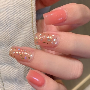 Pink gradient waterproof nail stickers with gold foil sequins on denim background