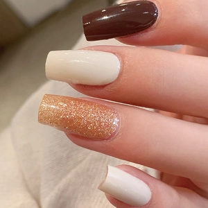 Solid color nail wraps in coffee, cream, and orange glitter for manicure decoration