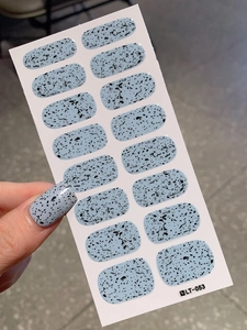 Detail of Easter egg shell pattern blue nail stickers showing speckled texture and fit