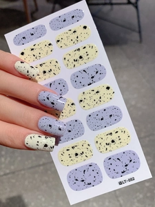 Detail of Easter egg speckled nail stickers in pastel yellow and lavender shades