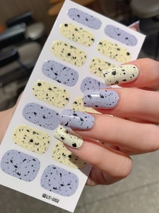 Detailed view of LT-052 Easter egg speckled nail wraps in soft yellow and purple colors