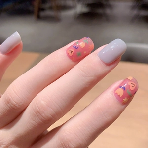Smoky blue hand-painted nail stickers with floral patterns on a manicured hand