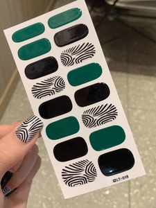Macro detail of waterproof black zebra pattern and green glossy full-wrap nail polish stickers
