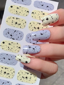 Detail of speckled Easter egg nail stickers in lavender and pastel yellow matte finish