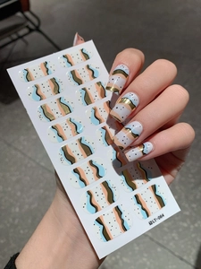 Detail of LT-064 self-adhesive nail stickers with gold wave pattern and blue accents