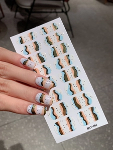 Detailed view of LT-064 nail stickers with wavy art patterns and golden line accents