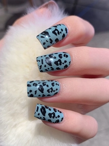 Macro detail of foggy blue square fake nails with black leopard print pattern