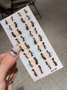Detail of LT-064 self-adhesive nail stickers with gold wave patterns and blue accents