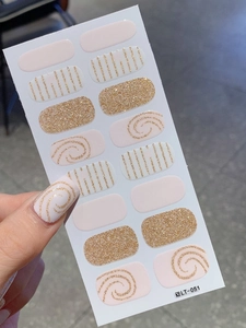 Detail of light pink and gold glitter nail stickers with heart and line patterns