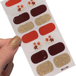 Autumn maple leaf nail stickers set with red tones and gold glitter for DIY manicures