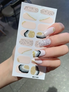 Detail view of LT-055 nail wraps featuring marble textures and gold curved lines
