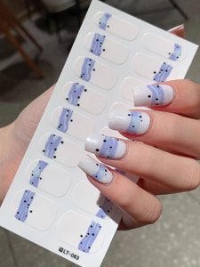 Macro detail of LT-063 nail stickers with white fluid lines and black polka dots