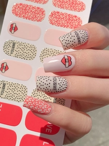 Detailed close-up of self-adhesive heart and polka dot nail art stickers on fingernails