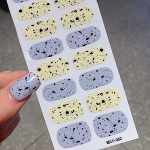 Easter egg pattern nail stickers in purple and yellow with black splatter textures