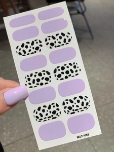 Detail view of LT-058 nail art stickers with lavender purple and black cow print designs