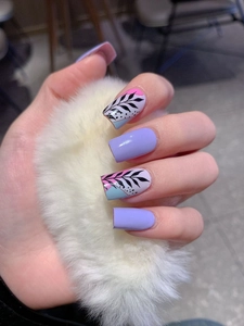 Detail of light purple nail stickers with hand-painted leaves and blue accents