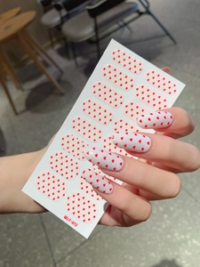 Detail of LT-072 nail stickers with red heart patterns on creamy white base on nails