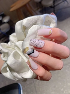 Detailed view of long square press-on nails with pink marble waves and gold glitter