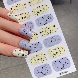 Easter egg pattern nail stickers in lavender and cream yellow speckled design