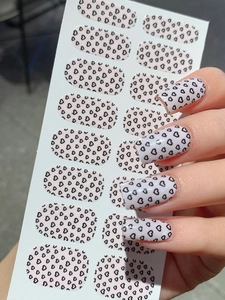 Macro view of self-adhesive heart pattern nail stickers in light pink and black