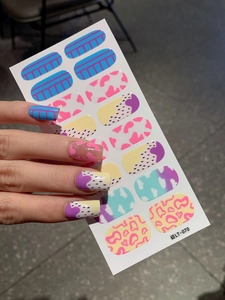 Detail of colorful nail art stickers featuring animal prints and abstract patterns