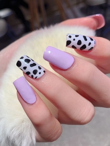 Long square leopard print nail tips with lilac purple and black white cow pattern design