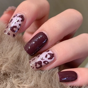 Short square leopard print and deep burgundy nail stickers on glossy finish hands