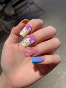 Close-up of long trapezoid nail stickers with purple dots and pink heart patterns