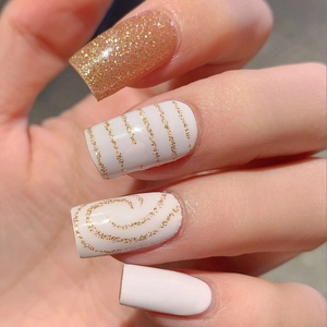 Pink and gold glitter square fake nails with heart patterns and striped DIY nail art design
