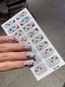 Detailed view of gray graffiti style nail wraps with gold foil and abstract art patterns